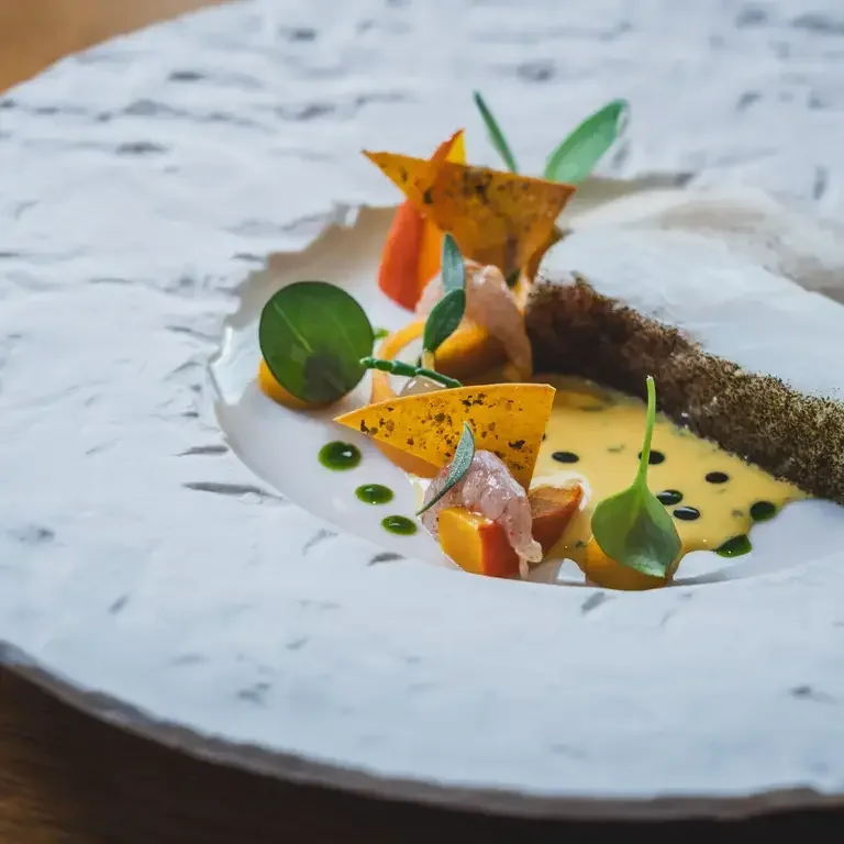 Turbot, shrimp, kuri squash and marigold sauce at Moor Hall.