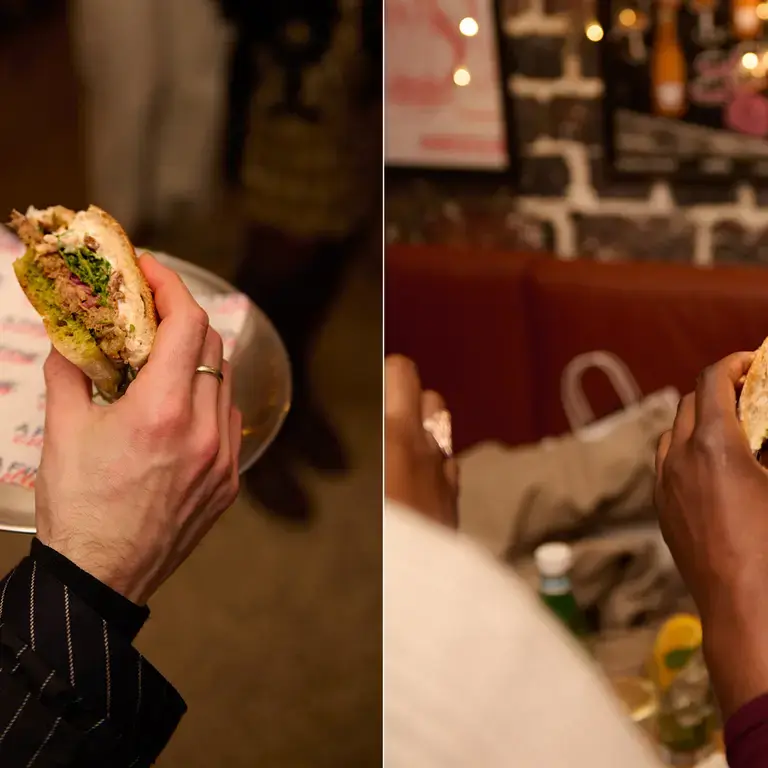 The A Fine Collab lamb sandwich being held by two different people.