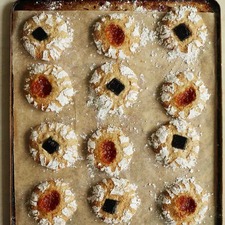 Hazlenut and jam biscuits by Twelve Triangles on a baking tray.