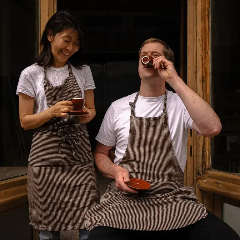 Chefs Kyu Jeon and Duncan Robertson drinking coffee outside Dongnae.