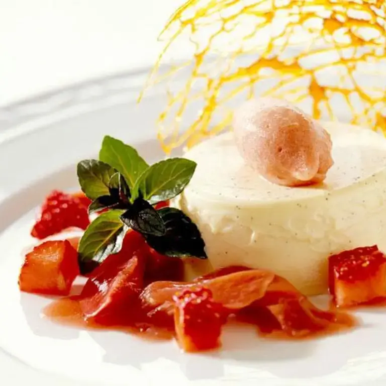 An elegently plated panna cotta with sugarwork.
