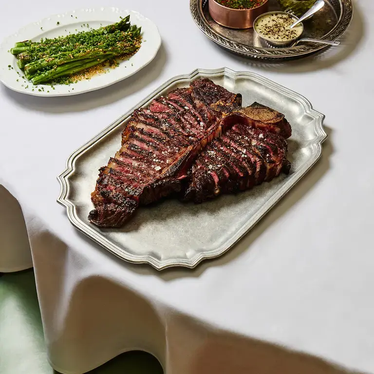Steak, vegetables and sauces at Sunny's Steakhouse.