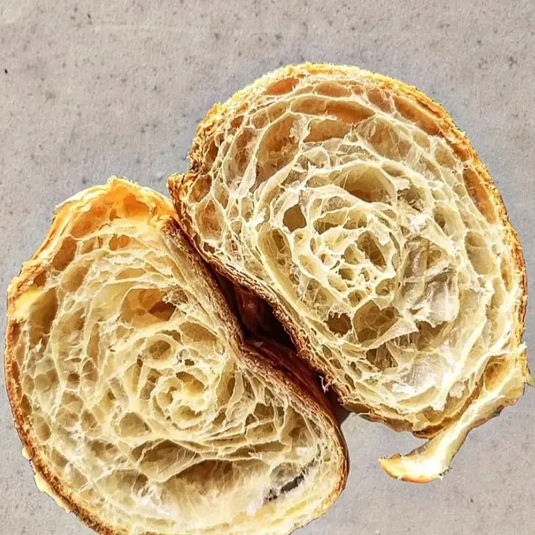 Croissant, cut in half and open, at Sablé Croissanteria.