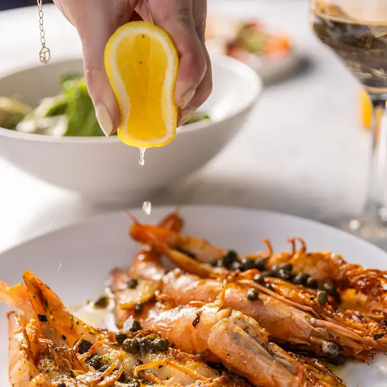 Squeezing citrus over prawns at Casa Ó.