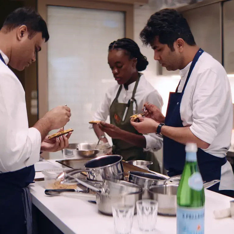 Chefs preparing dishes at Firecat.