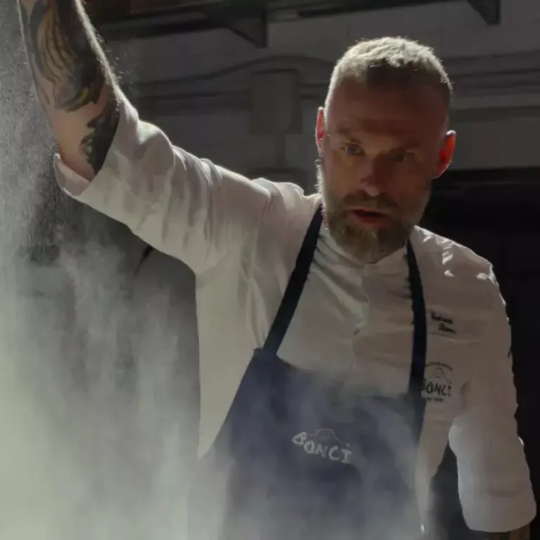 A man dusting flour from a height.