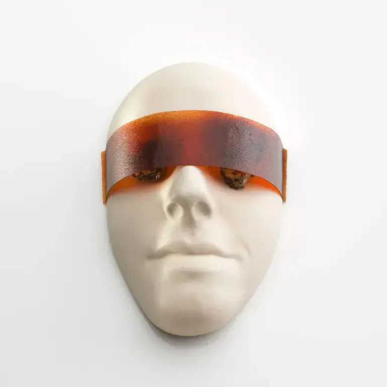 A white plastercast face with visor