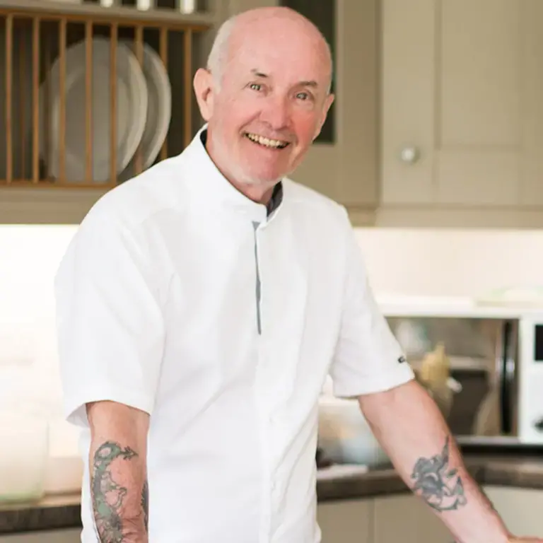 A smiling male chef. h