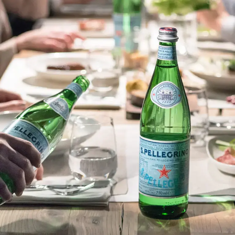 table of people with S. Pellegrino water bottles