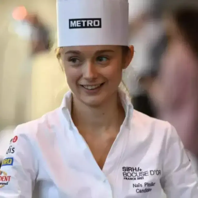 A young female chef in whites.