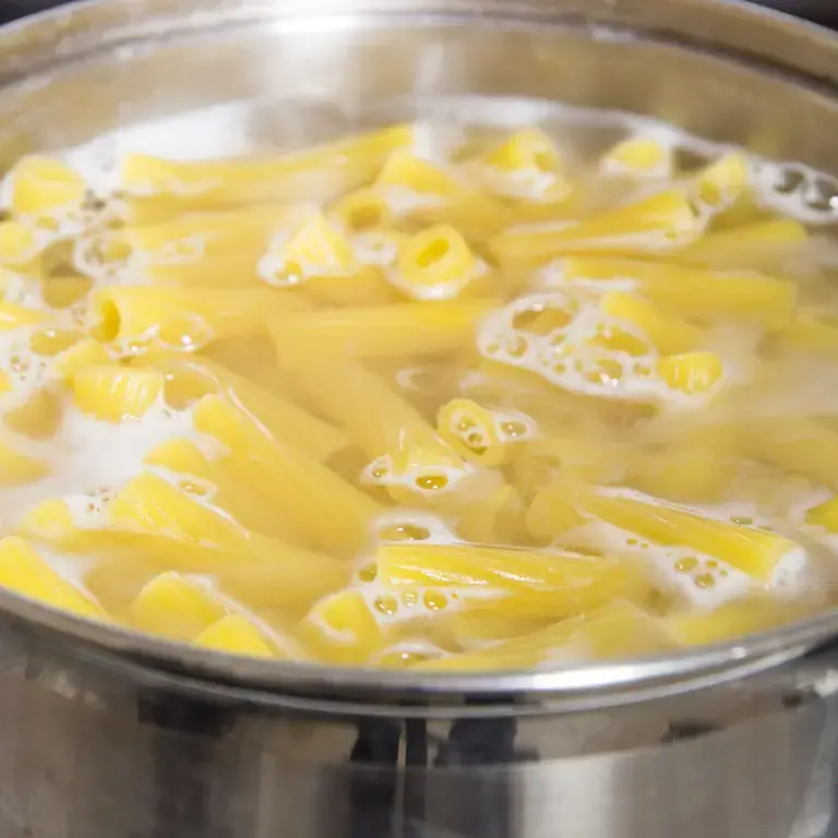 pasta cooking in a pan of boiling water