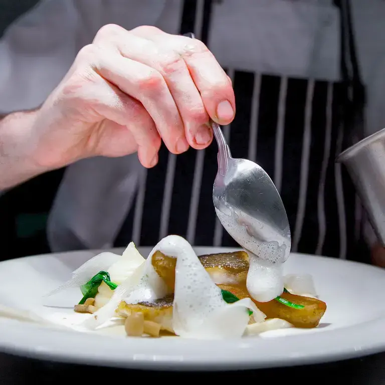 Close up on a young chef hand cooking