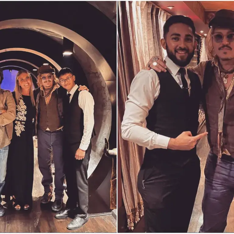 Johnny Depp posing with staff and friends at Varanasi restaurant
