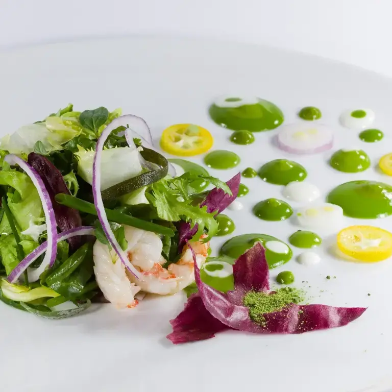 Green salad with seaweed and red prawns.