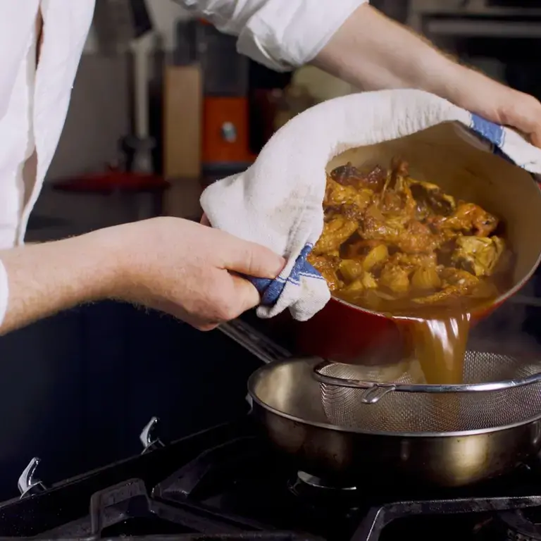 Pan jus gras being sieved.