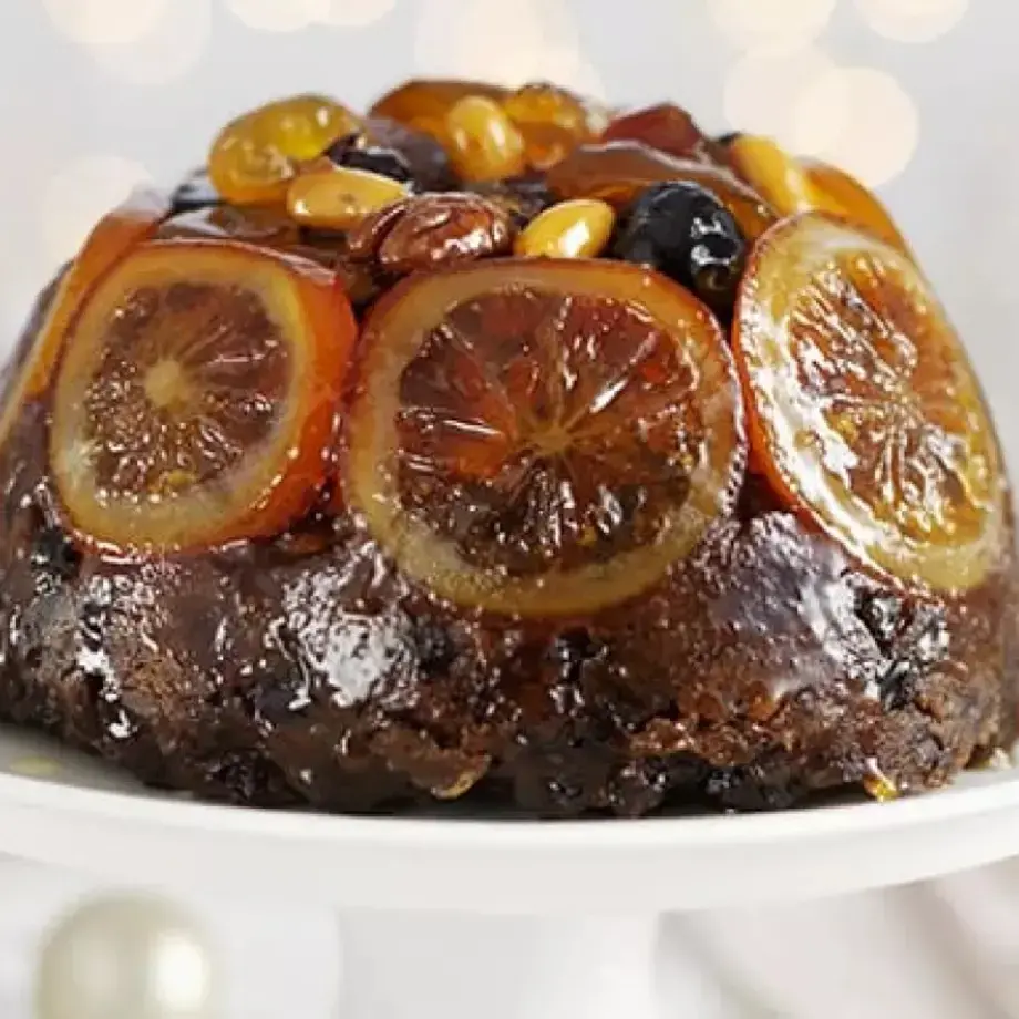 Christmas pudding decorated with orange slices.