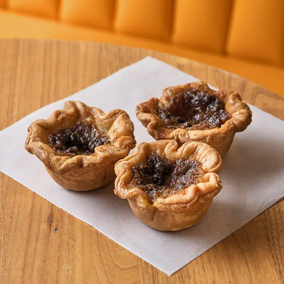 Butter tarts by Jonny Lake, on a table.
