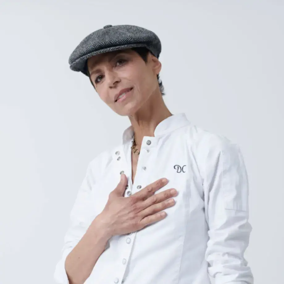 Chef Dominique Crenn in a flat cap.