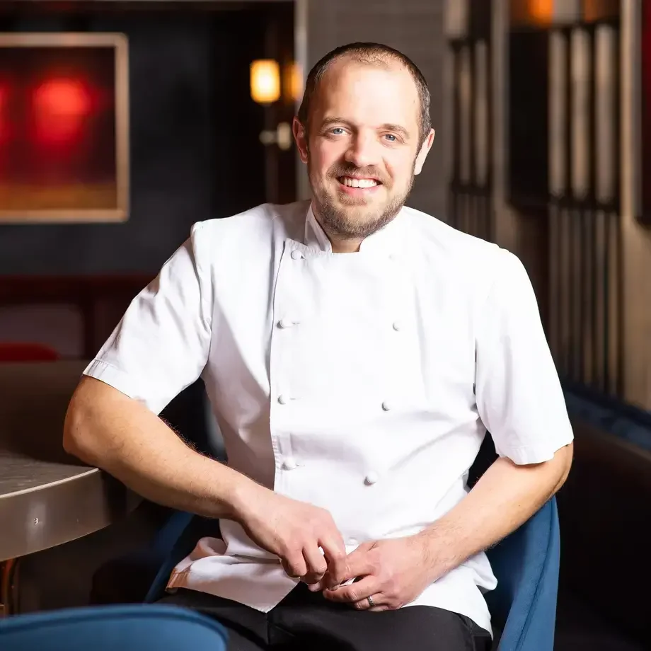 Chef James Knappett sitting on a chair.