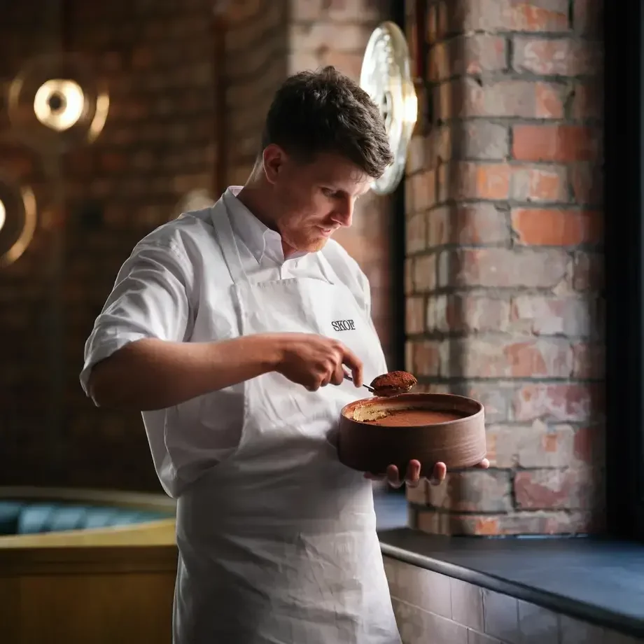Chef Tom Barnes serving tiramisu.