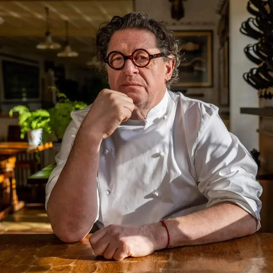 Chef Marco Pierre White in chef's whites and spectacles.