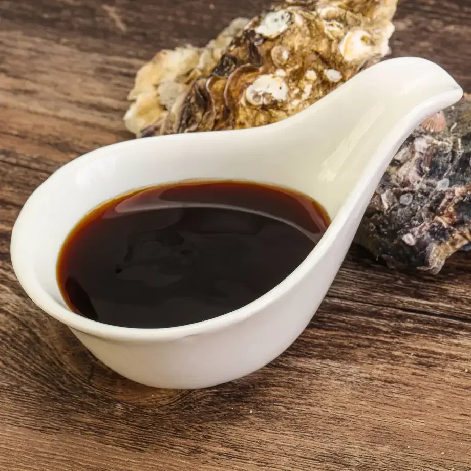 Oyster sauce and two oyster shells.