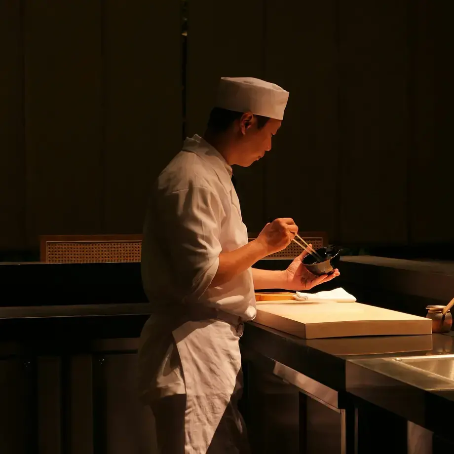 A sushi chef in the kitchen.
