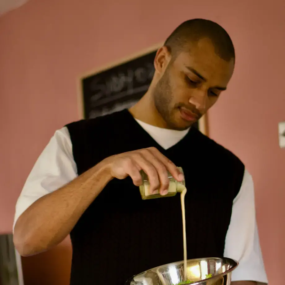 Joseph Denison Carey pouring a liquid into a mixing bowl.