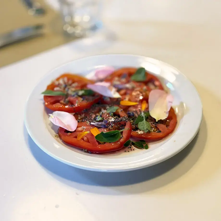 Tomato carpaccio with mountain flowers.