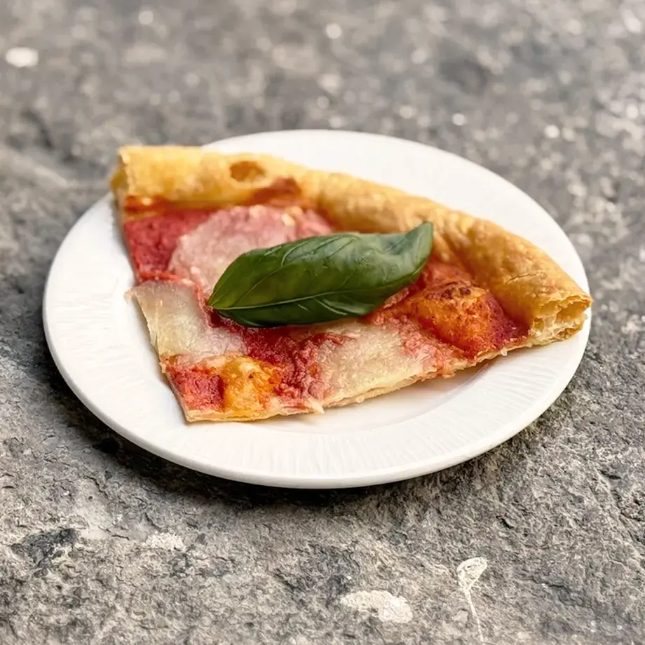 Puff pastry pizza with tomato and pesto.