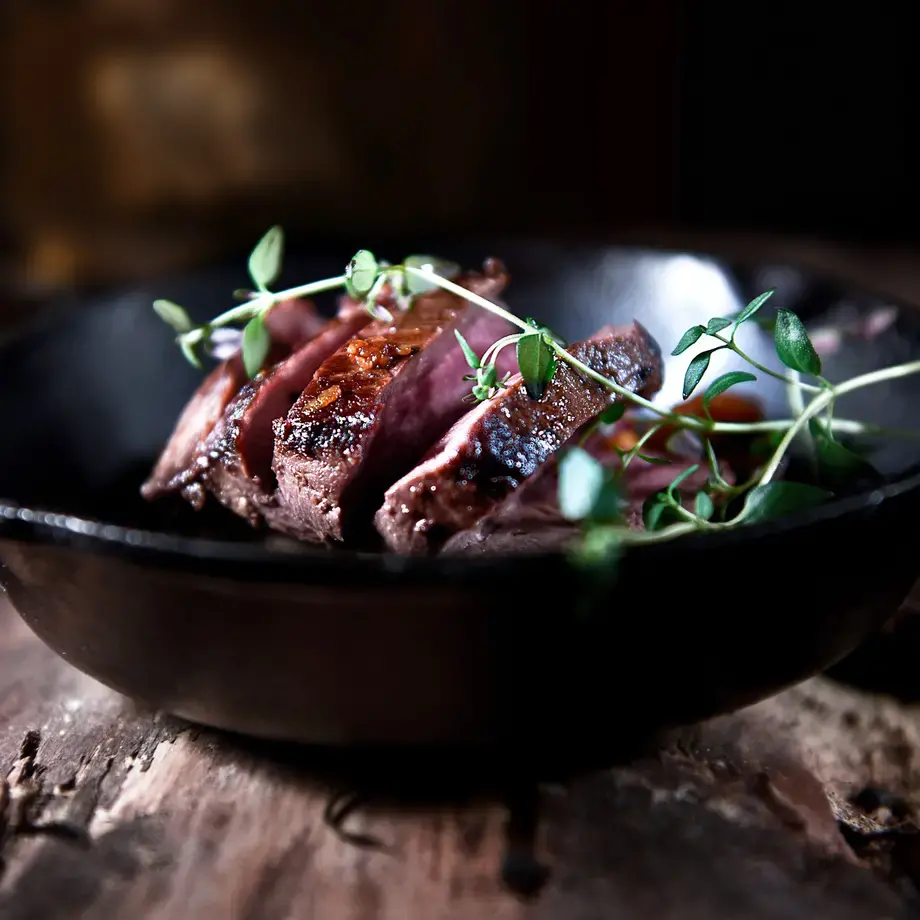 Venison dish in a dark bowl.