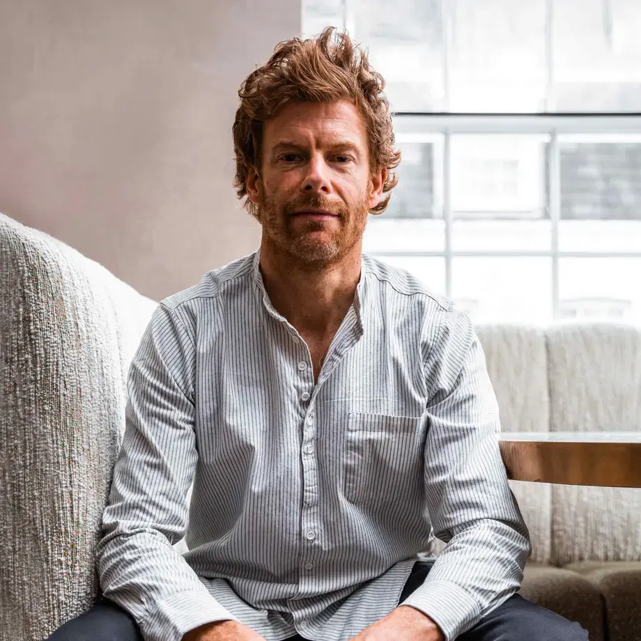 Chef Tom Aikens, seated in casual clothes.