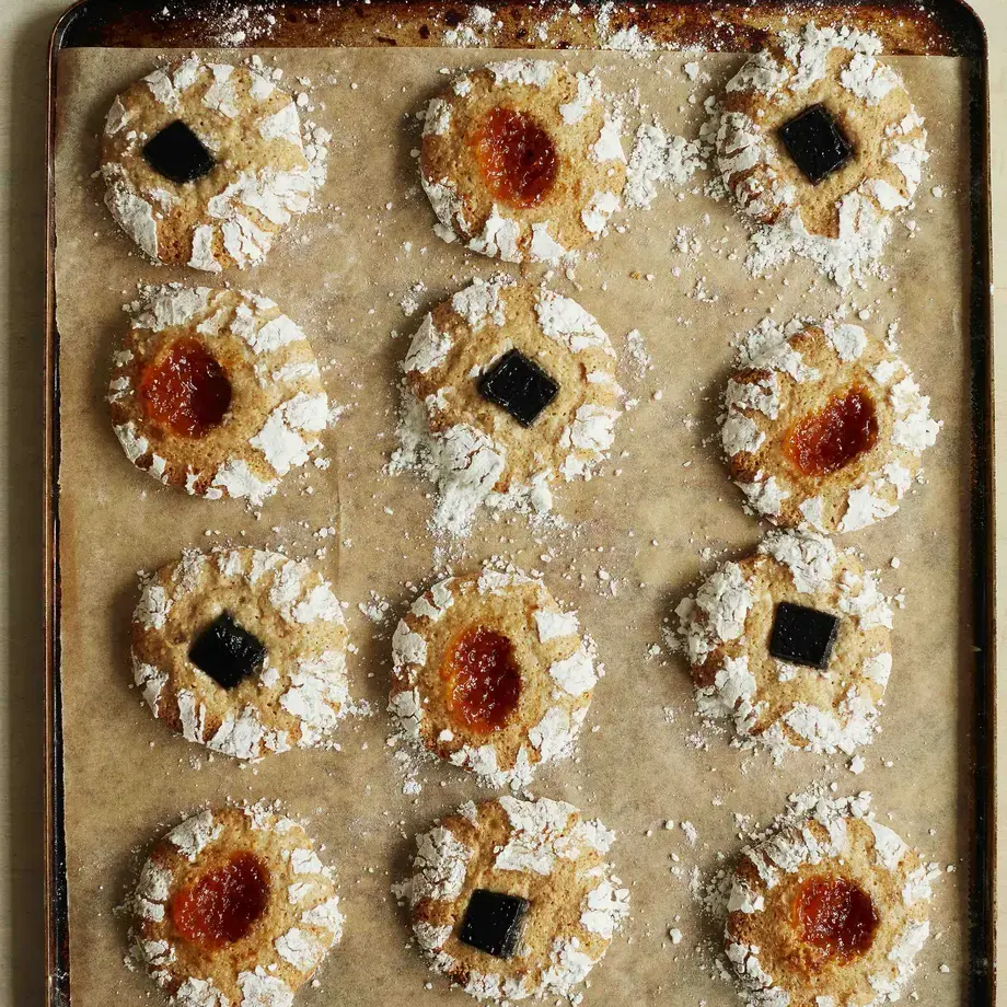 Hazlenut and jam biscuits by Twelve Triangles on a baking tray.
