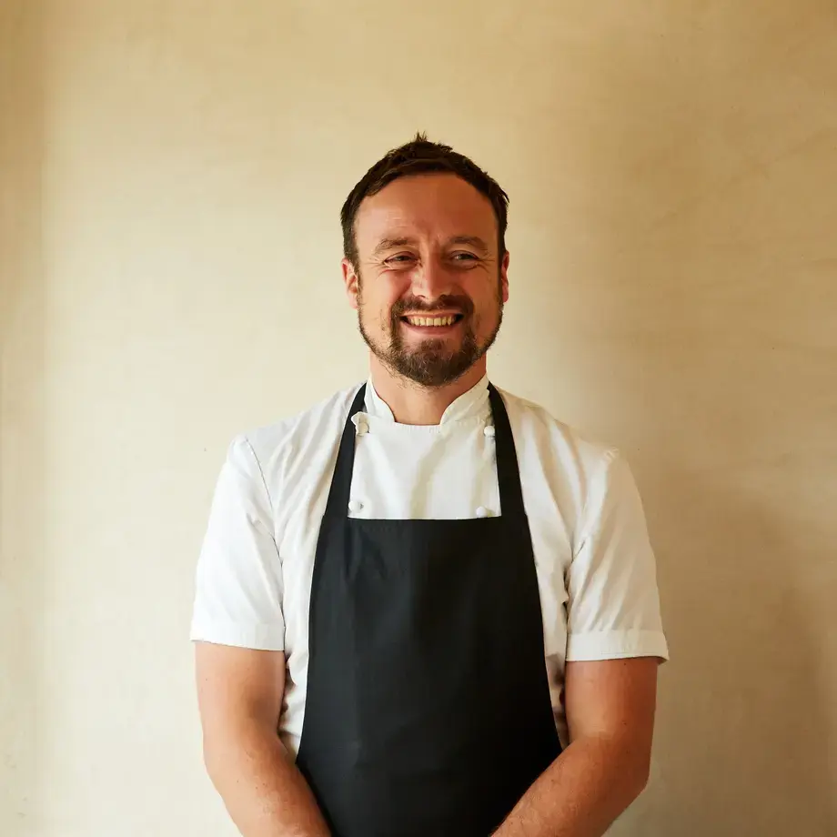 Chef Sam Carter smiling in an apron