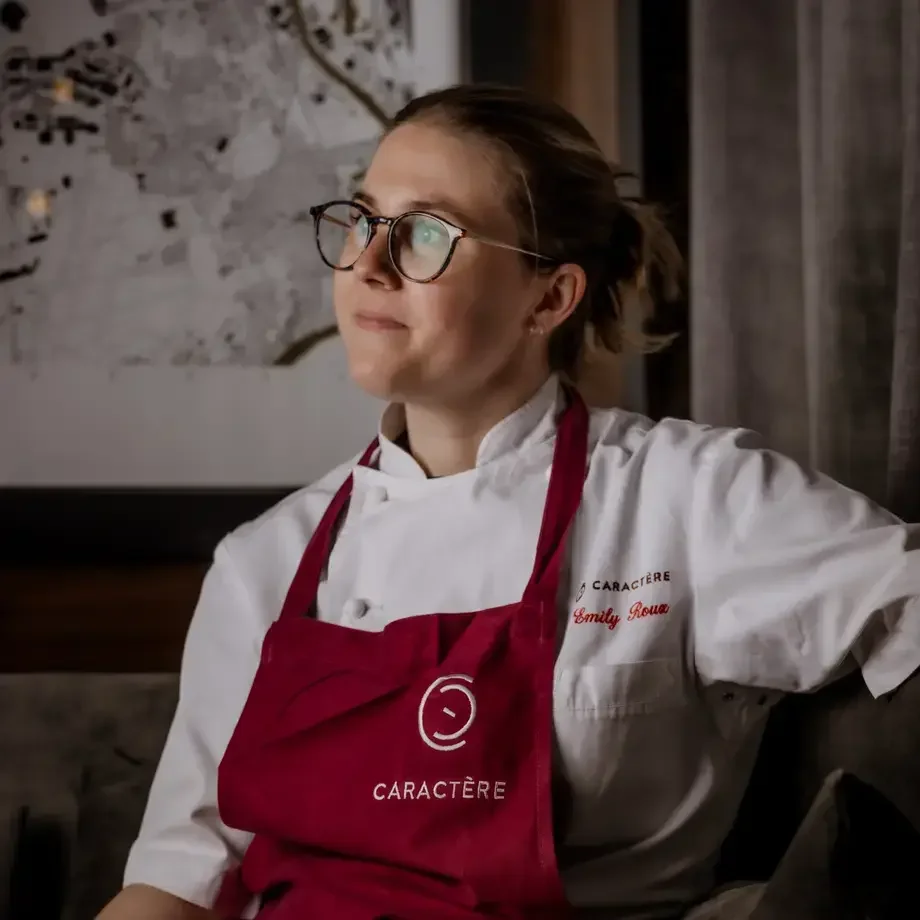 Chef Emily Roux in a red apron.