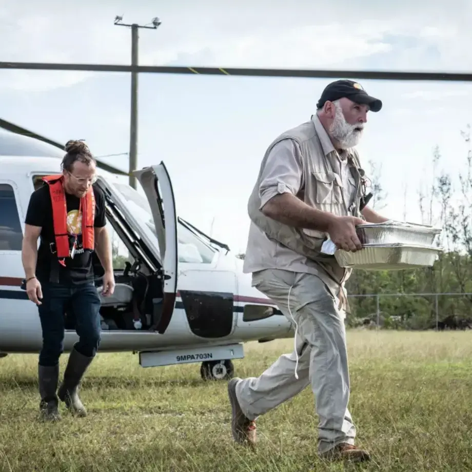 Jose Andres and another man running from a helicopter