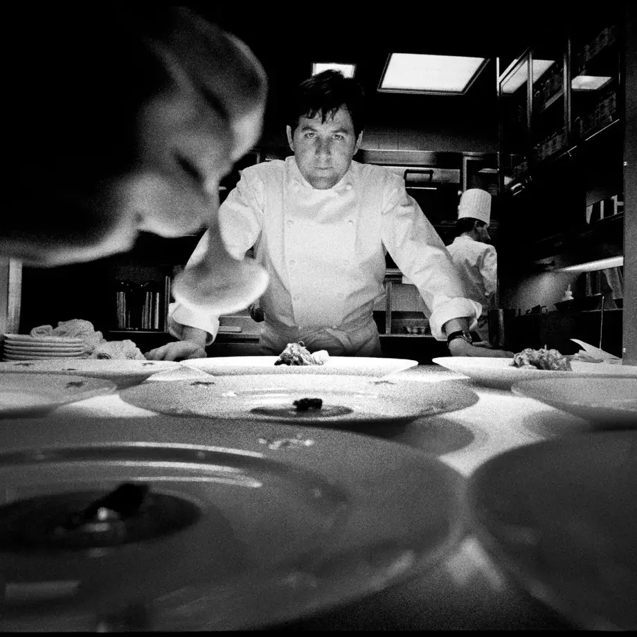 chef Charlie Trotter standing at the pass in a kitchen