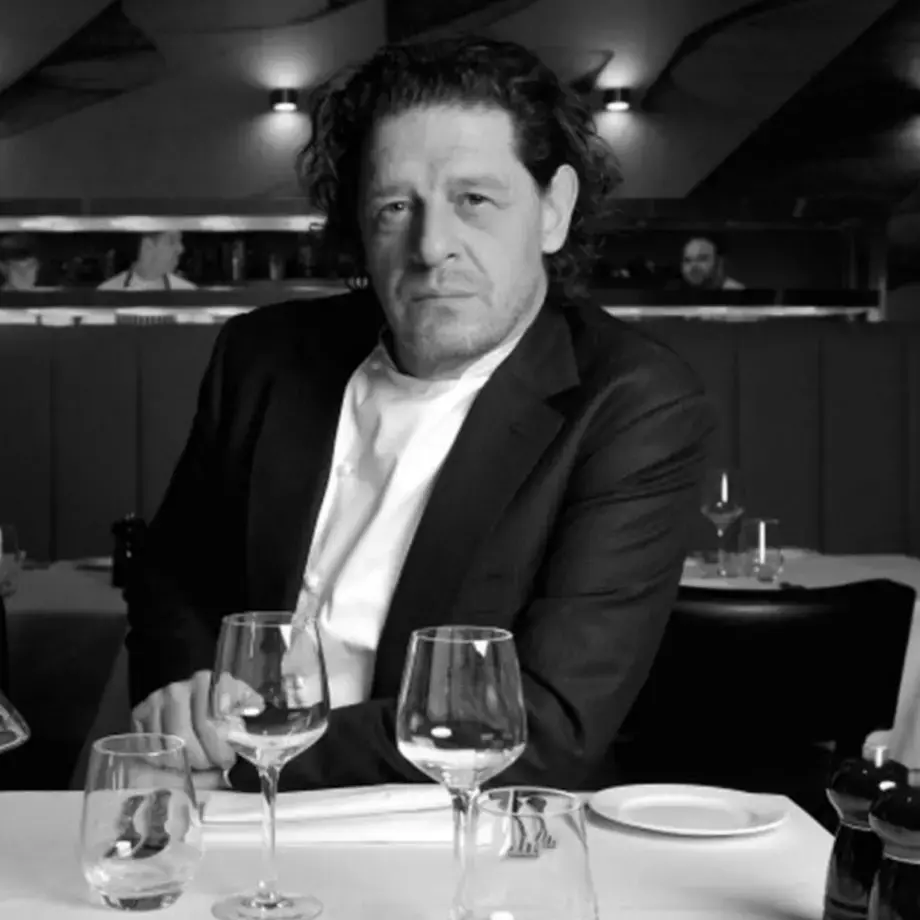Marco Pierre White sat at a restaurant table.