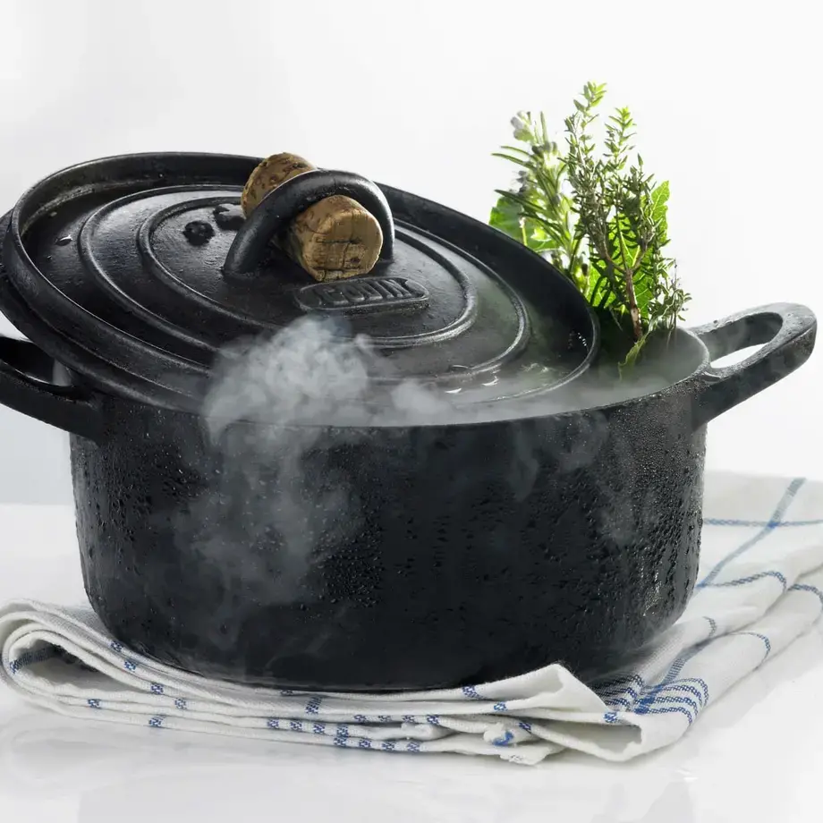 A steaming, black Dutch oven.