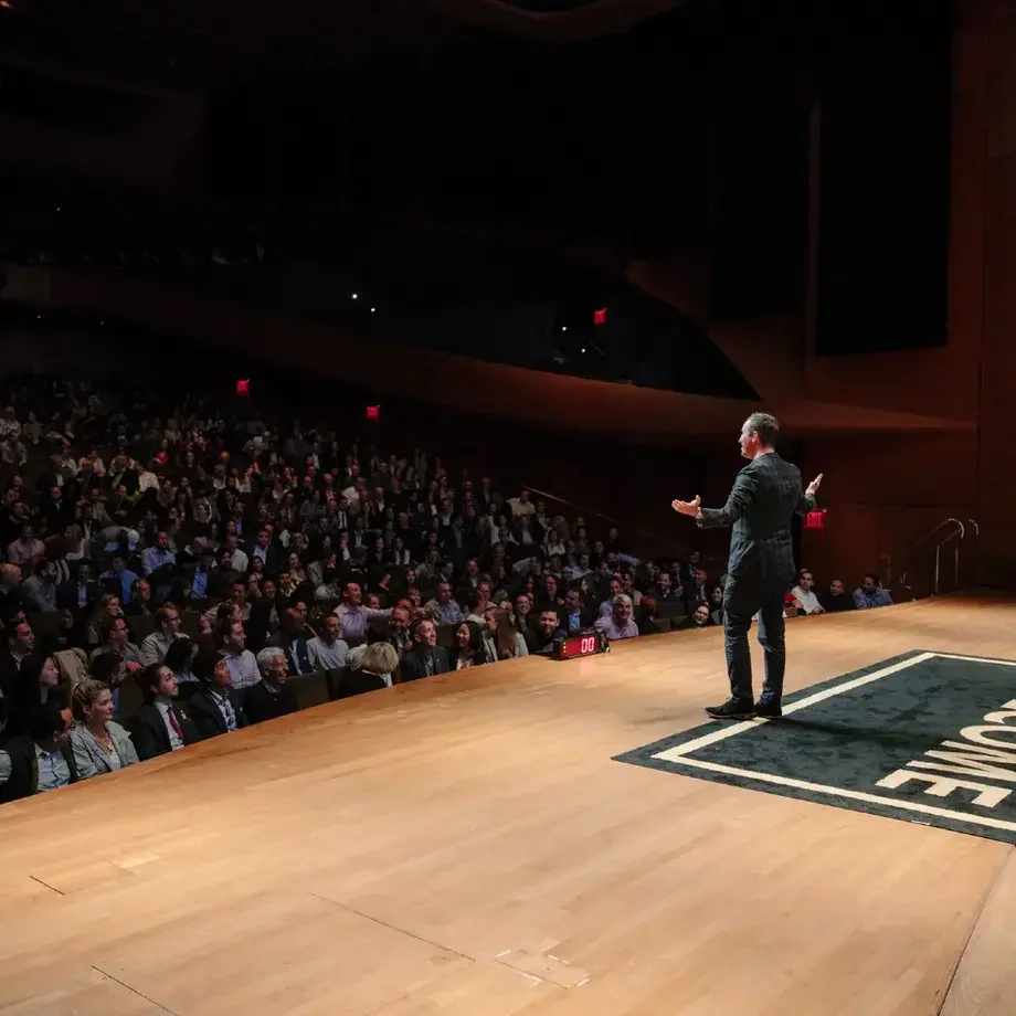 Will Guidara on stage presenting to a packed theatre