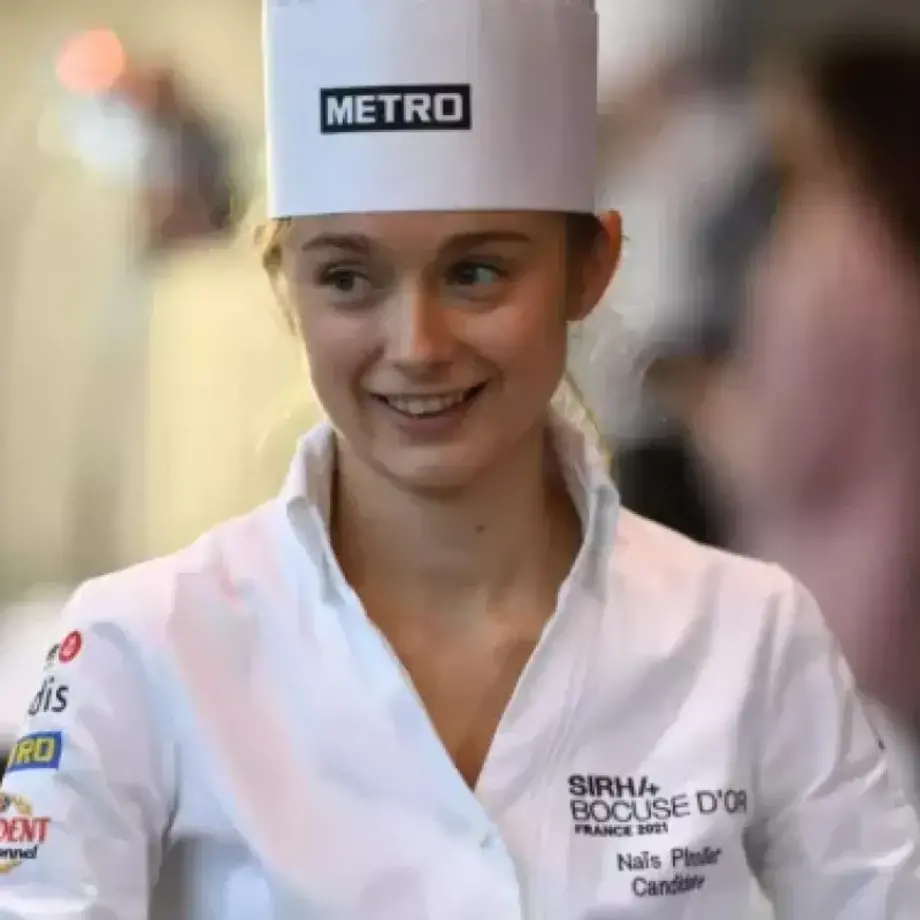 A young female chef in whites.