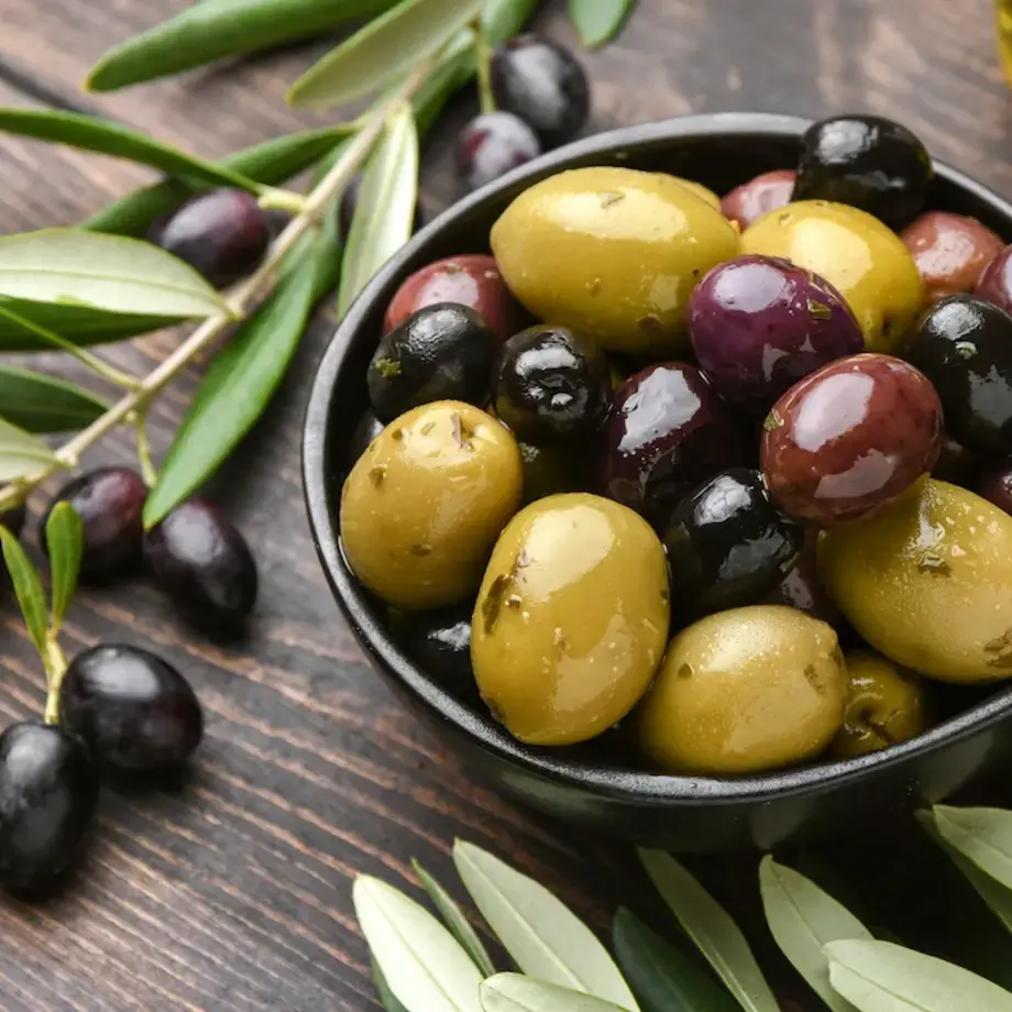 Bowl containing different olive varieties.