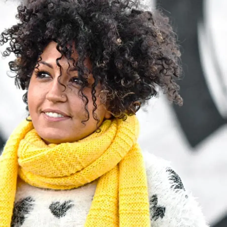 Journalist Claudia Concas wearing a yellow scarf.