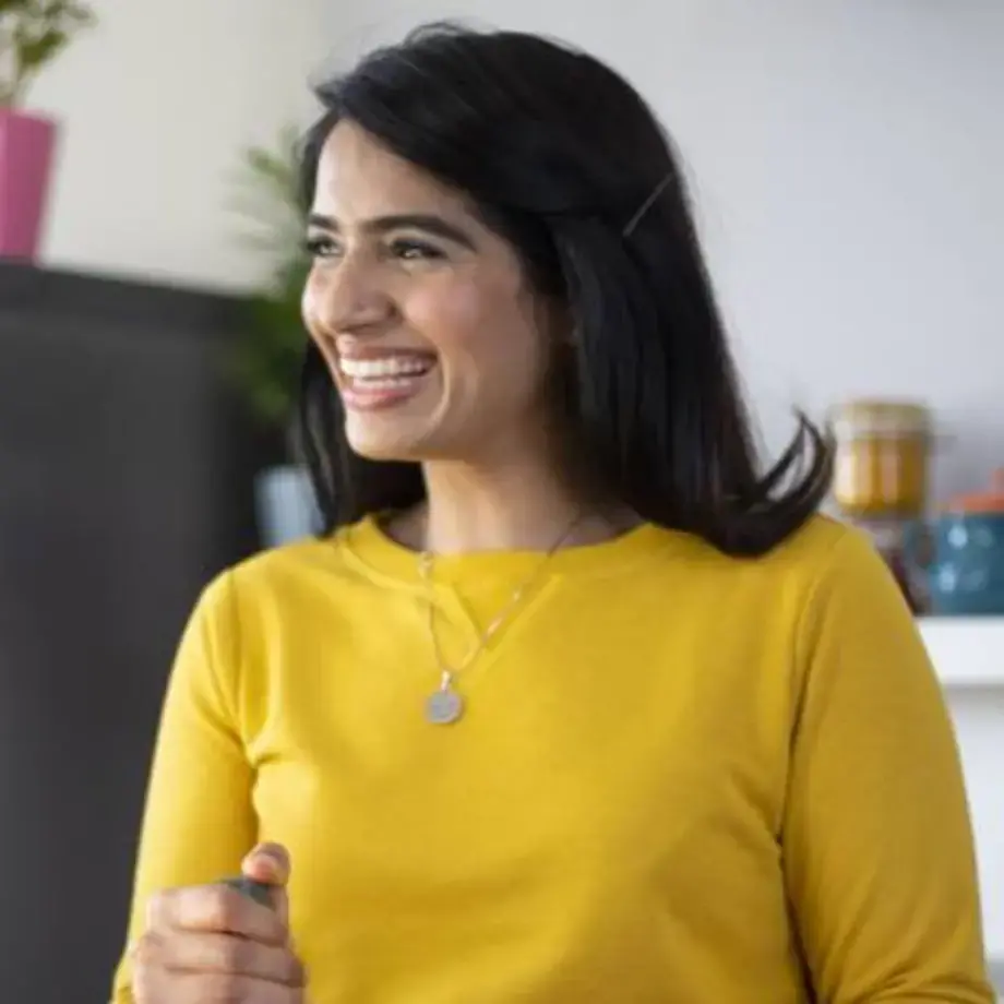 Chef Monica Haldar in a yellow sweater.