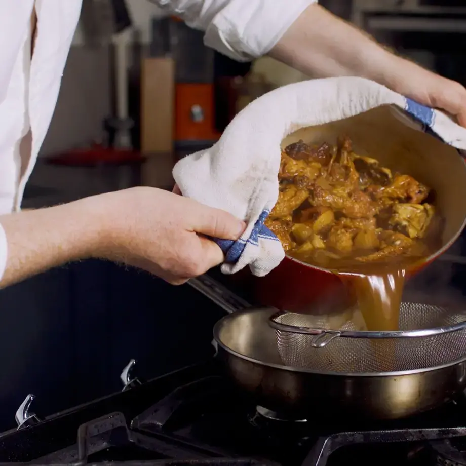 Pan jus gras being sieved.