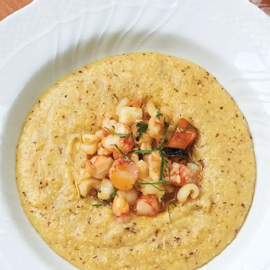 Polenta with seafood, cheese and basil.