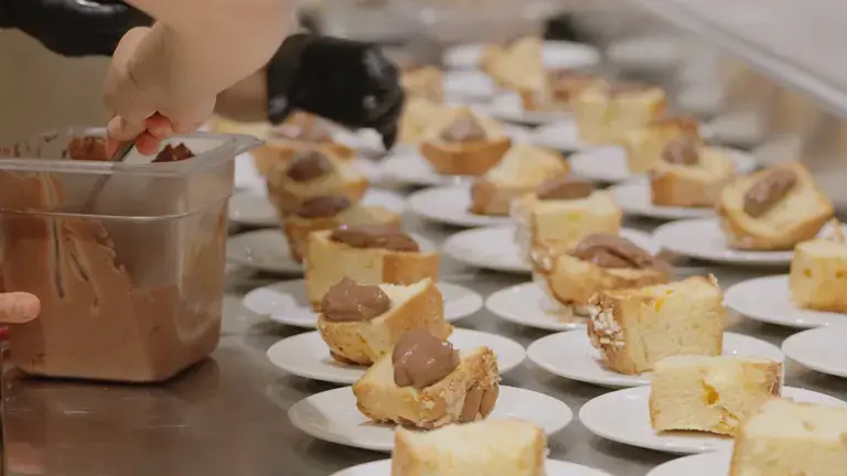 Slices of panettone served with chocolate cream in a professional pastry presentation