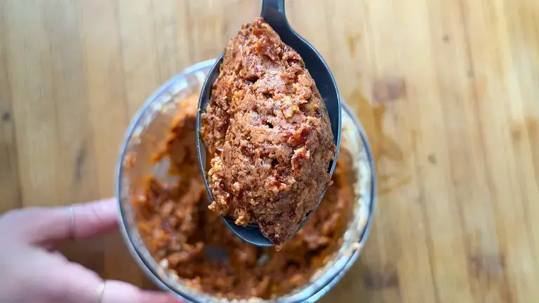 Red pesto on a spoon.