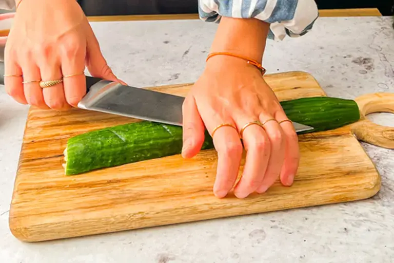 Chef mashing cucumber.