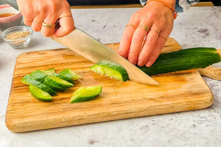 Chef cutting cucumber.